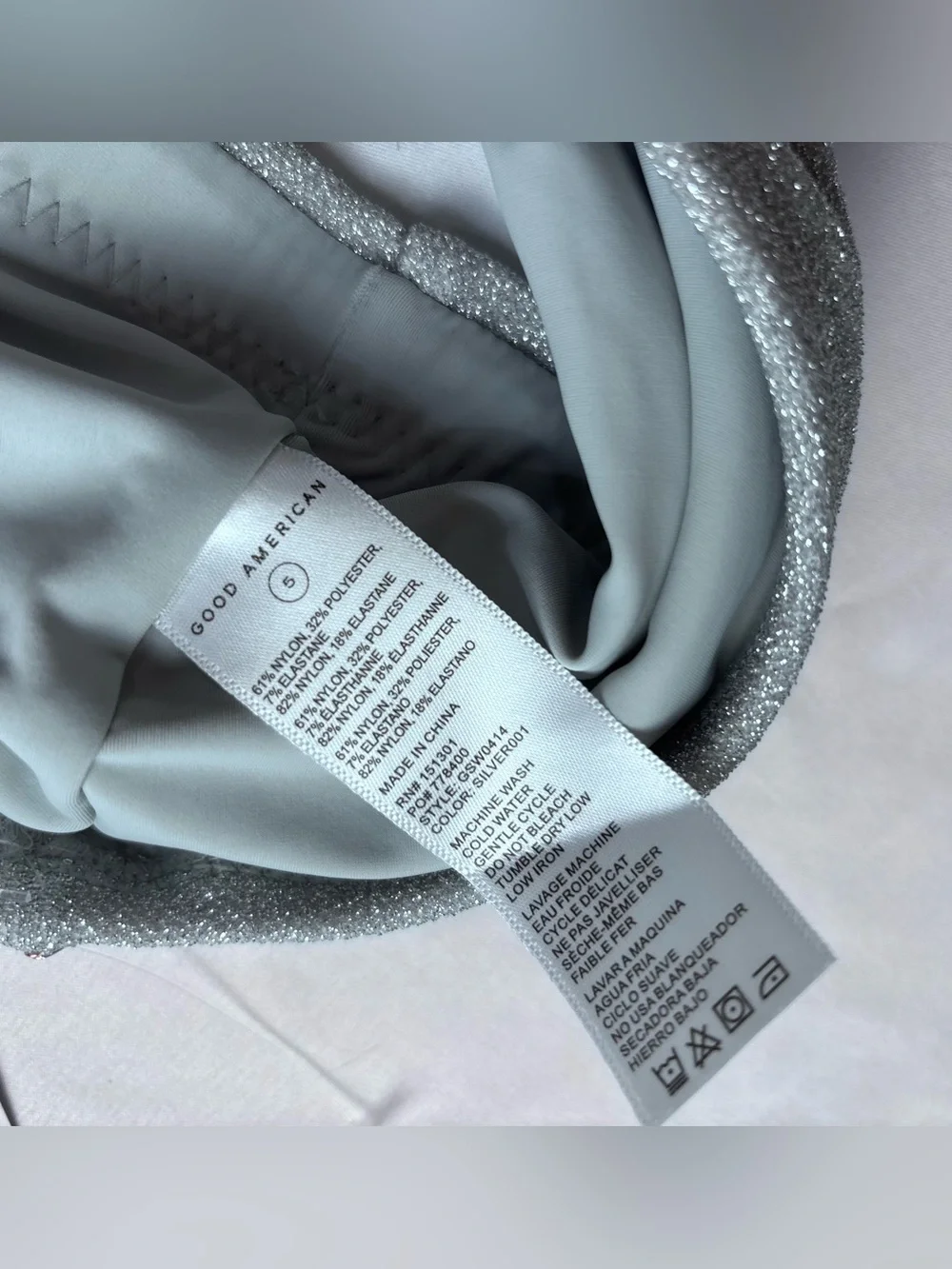 This Good American bandeau top features a shimmering silver fabric